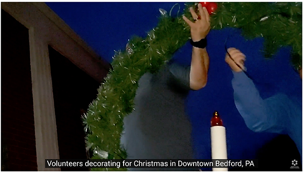 Volunteers decorating for Christmas in downtown Bedford